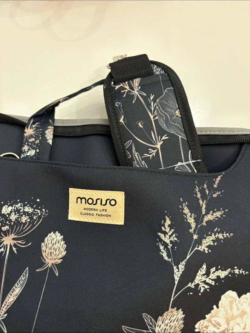 Mosiso brand Black Floral Laptop Bag with Cream Accents